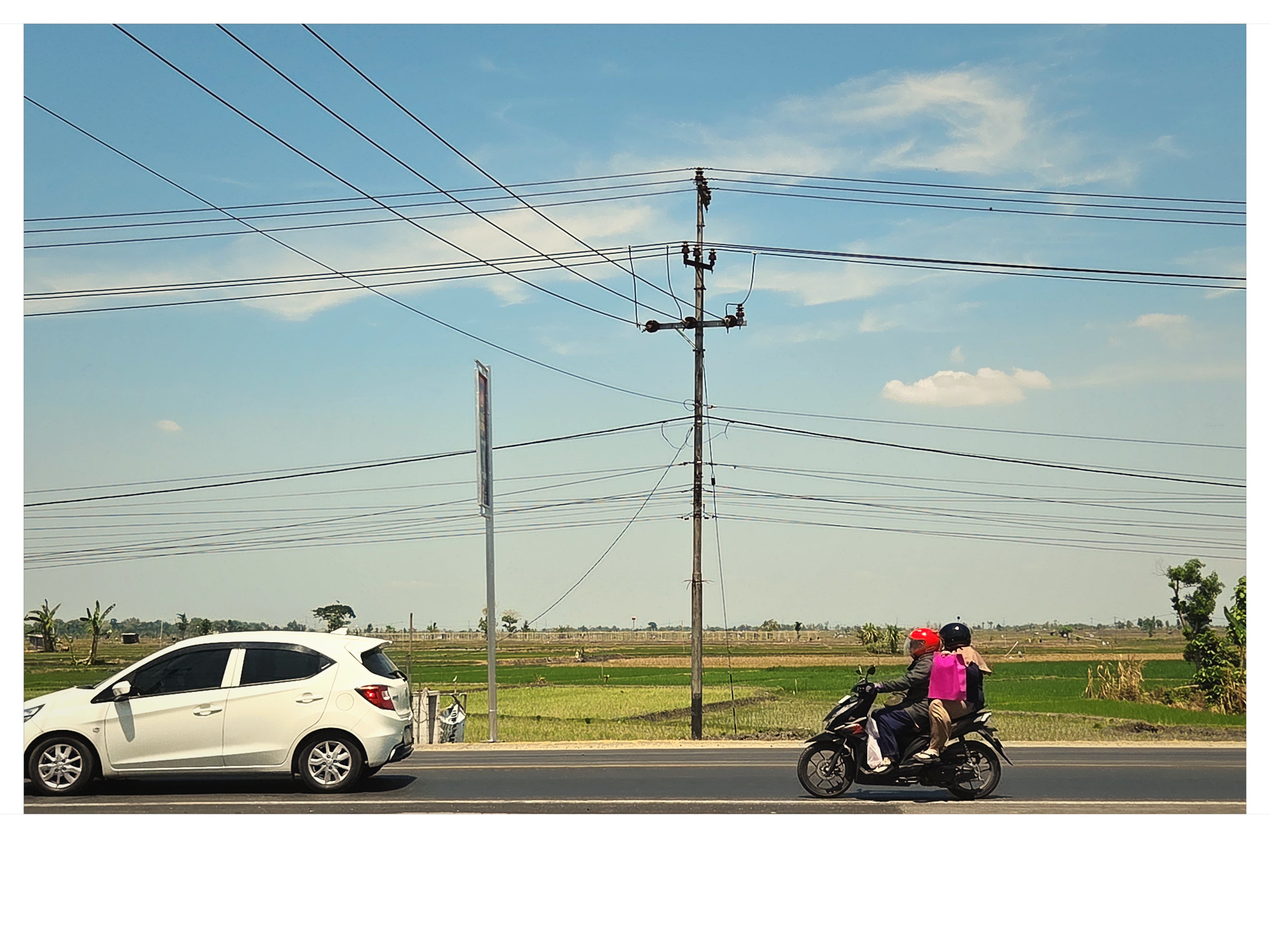 Countryside road with motorbike passing agricultural fields shot on NeoFilm Amber Transit 200