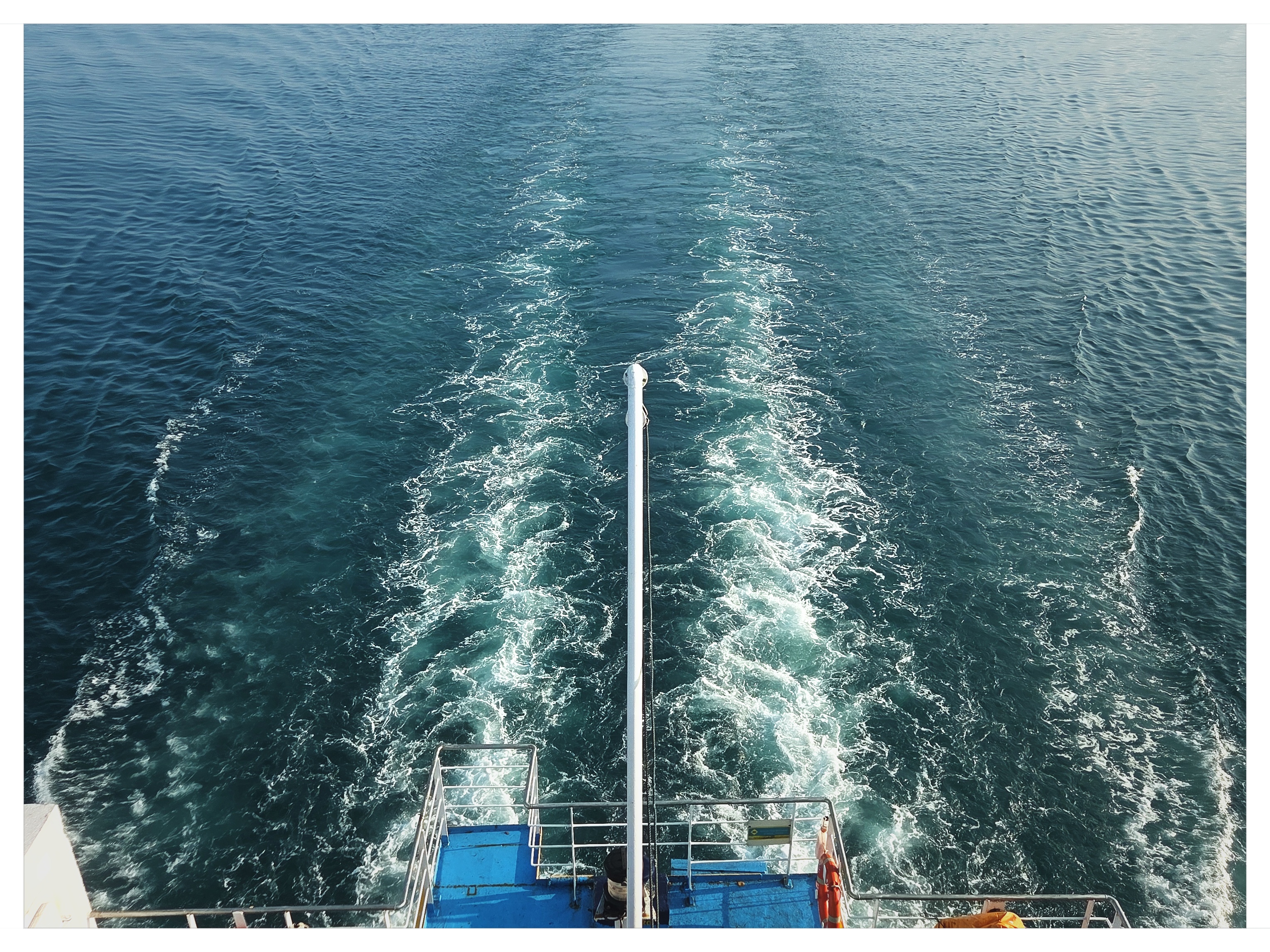 Churning ocean water wake behind moving vessel at Port of Gili Mas shot on NeoFilm Superia 400