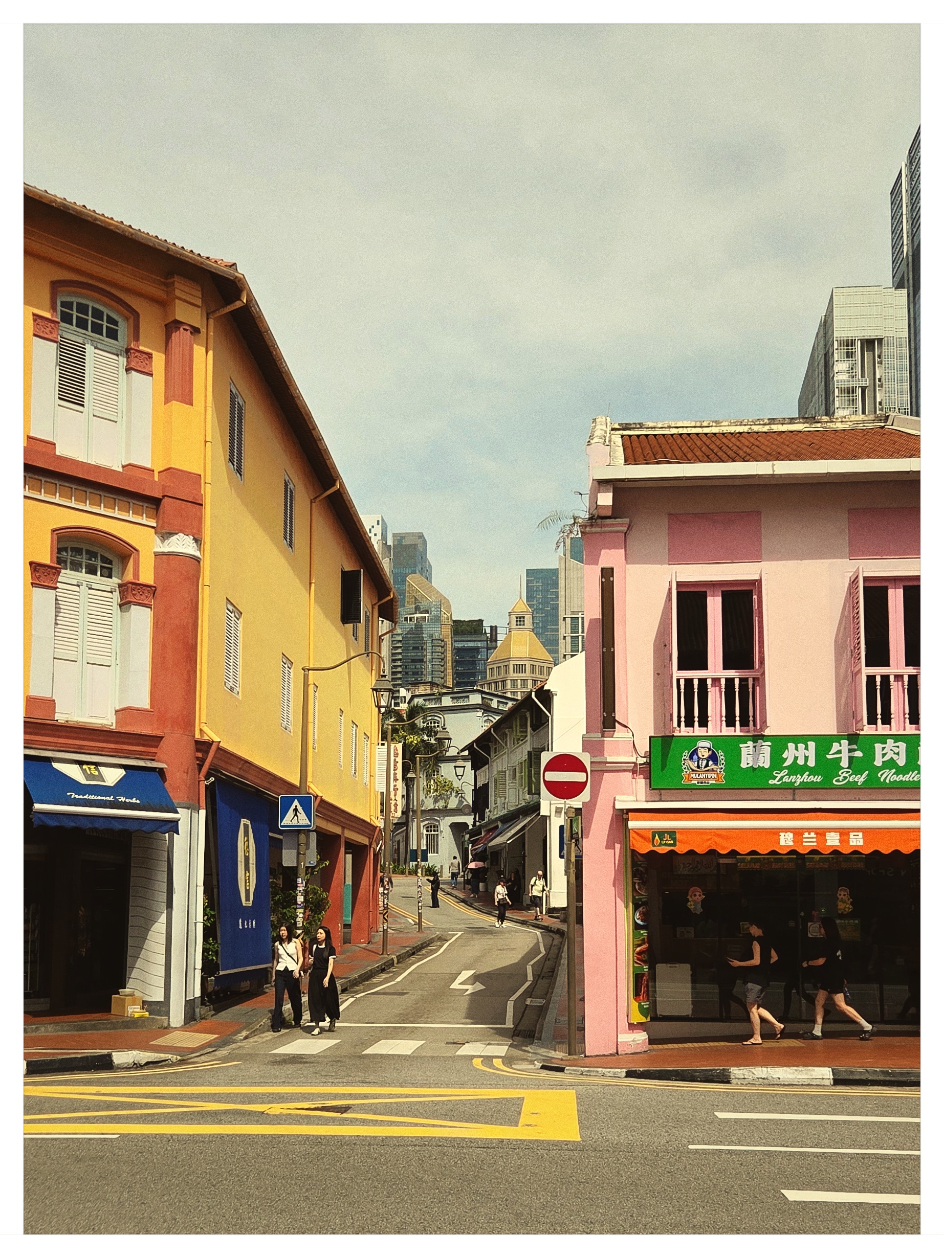 Yellow and pink historical shophouses in Singapore Chinatown shot on NeoFilm FX Daily 400